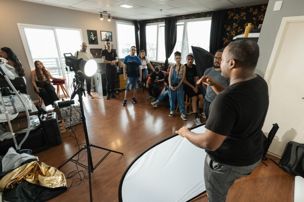 A lively photography workshop featuring a diverse group of participants and professional setup.